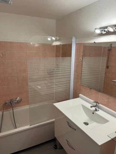 une salle de bain avec un lavabo, une douche et une baignoire dans l'établissement Cocon Familial, à Saint-Raphaël