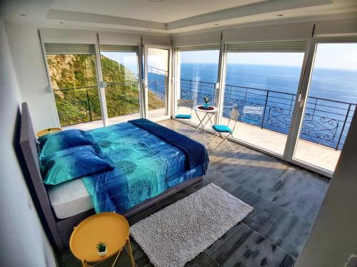 a bedroom with a bed and views of the ocean at Charming Villa with Pool, Sea View in Zagora in Zagora