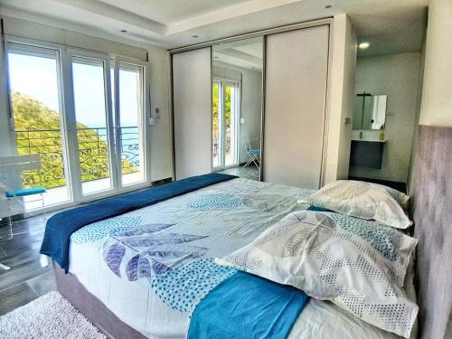 a bedroom with a large bed with a large window at Charming Villa with Pool, Sea View in Zagora in Zagora