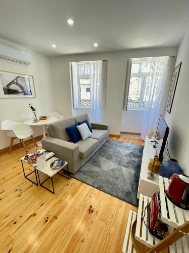 a living room with a couch and a table at 1118 Lofts in Porto