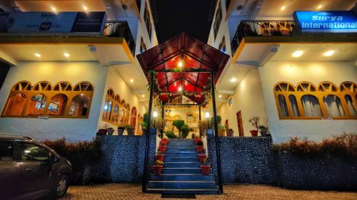 a building with a staircase in front of a building at Surya International Hotel Manali near Mall Road in Manāli