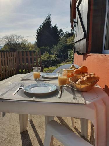 a table with plates of food and a bowl of bread at Casa Do Monte Mondim in Mondim de Basto