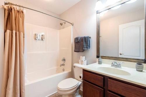 a bathroom with a sink and a toilet and a tub at TWO-STORY Townhouse Kentucky Horse Park at Kittens Joy in Lexington
