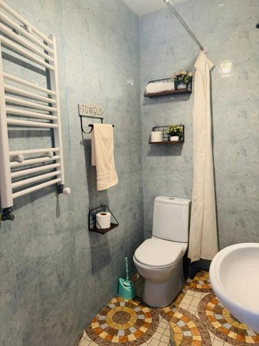 a bathroom with a toilet and a sink at Sky Guest House in Tbilisi City