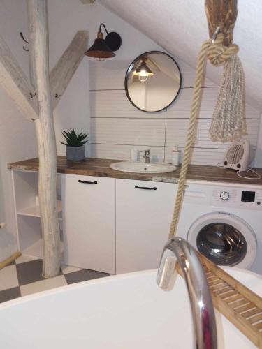 a bathroom with a sink and a washing machine at Małopolskie Swojskie in Olszyny