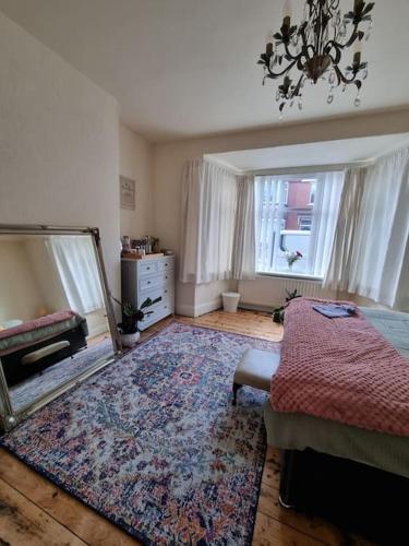 a bedroom with a mirror and a bed and a rug at Stay at 128 in Walker Gate
