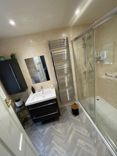 a bathroom with a sink and a shower at Stay at 128 in Walker Gate