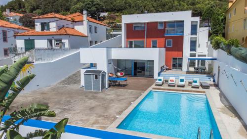 an aerial view of a house with a swimming pool at Azores Dreams - Sea View House in Ponta Delgada