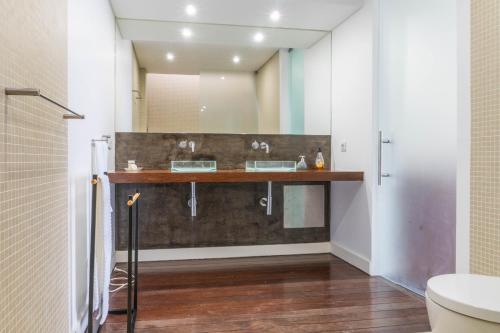a bathroom with two sinks and a mirror at Azores Dreams - Sea View House in São Roque