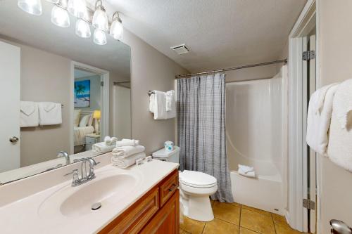 a bathroom with a sink and a toilet and a shower at Phoenix VI 807 in Orange Beach