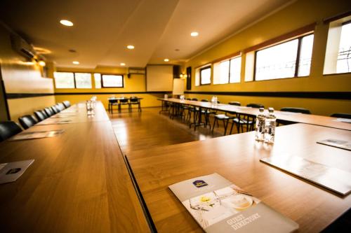 a large room with a long table and chairs at Ambassador Hotel in Timişoara