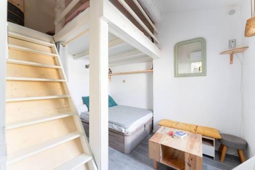 a small room with a bunk bed and a ladder at Coste Investissement - Le Perchoir in Marseille