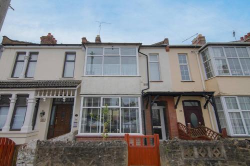a large house with a fence in front of it at Pass the Keys Cosy Stylish house near Southend in Southend-on-Sea