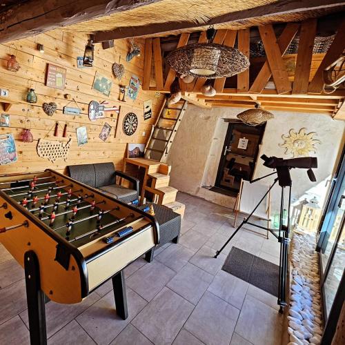 a room with a foosball table and a camera at LE GRAND LOGIS, chambre Santorin avec spa privatif 