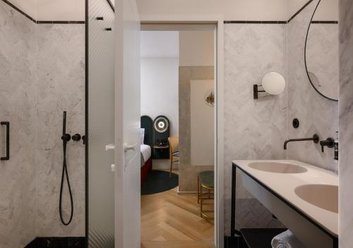 a bathroom with a sink and a shower at Montebelo Vista Alegre Lisboa Chiado Hotel in Lisbon