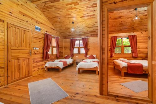 a bedroom with two beds in a log cabin at Cirali La Maison Hotel in Kemer