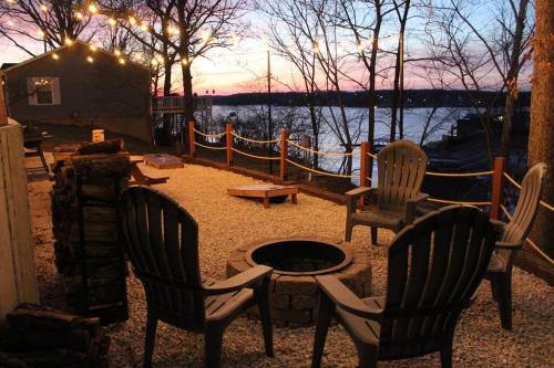 a group of chairs and a table and a table at Modern Getaway - New Outdoor Amenities! - Location in Osage Beach