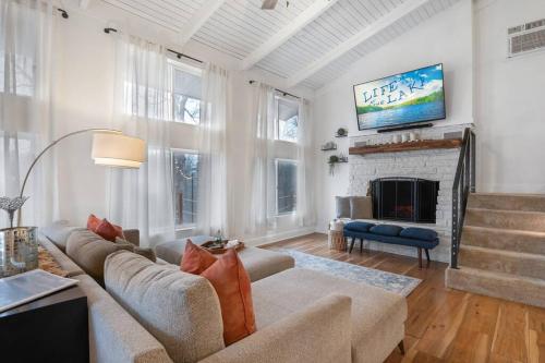 a living room with a couch and a fireplace at Modern Getaway - New Outdoor Amenities! - Location in Osage Beach