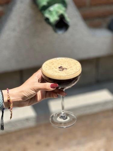 a woman holding a wine glass in her hand at Mestizo Antigua in Antigua Guatemala