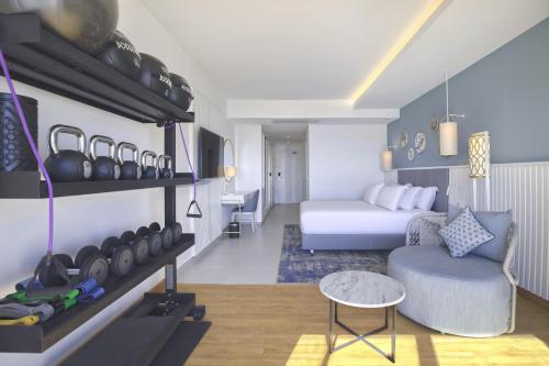 a living room with a bed and a couch in a room at Hilton Skanes Monastir Beach Resort in Monastir
