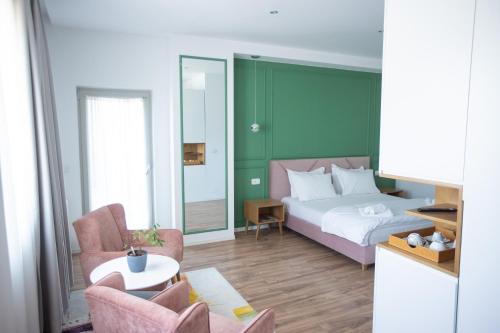 a bedroom with a bed and a table and chairs at Ginger Home Tirana in Tirana