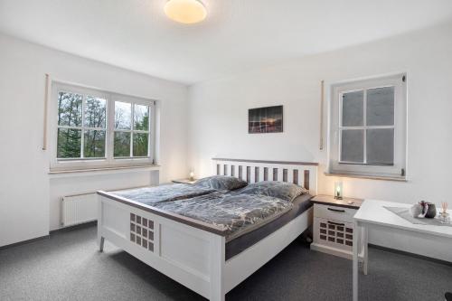 a white bedroom with a bed and a sink at Hönneblick in Balve