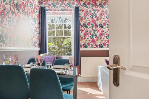 a dining room with a table and chairs and a window at Harbour Heights Plymouth - Centrally located - Parking - Ocean City Retreats in Plymouth