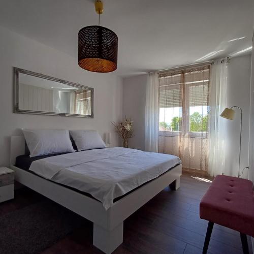 a bedroom with a large bed and a large window at Apartman West Side in Zaprešić