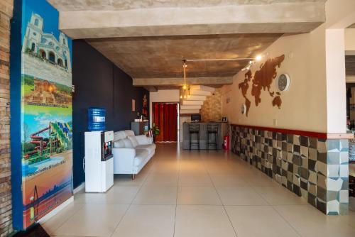 a hallway with a tile accent wall and a living room at Hotel Renty Beach in Encarnación