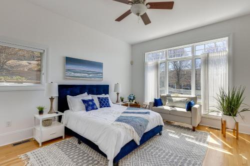 1 dormitorio con cama, sofá y ventanas en Hamptons Home Near Beaches with Pool and Water Views!, en Southampton