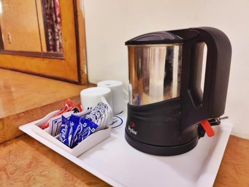 a coffee maker sitting on top of a counter at Surya International Hotel Manali near Mall Road in Manāli