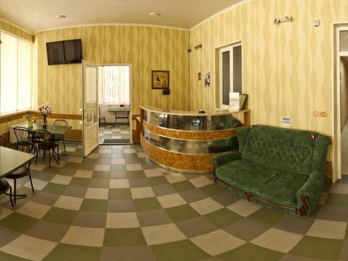 a living room with a couch and a table at Atrium Hotel in Melitopol