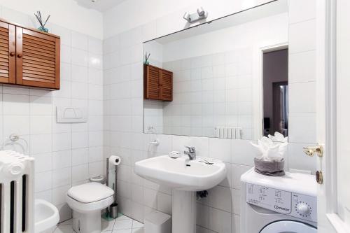 a white bathroom with a sink and a toilet at Como Luxury Suites - IL DUOMO in Como