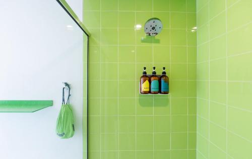 a bathroom with a shower with three bottles of wine at The Gallatin in Nashville