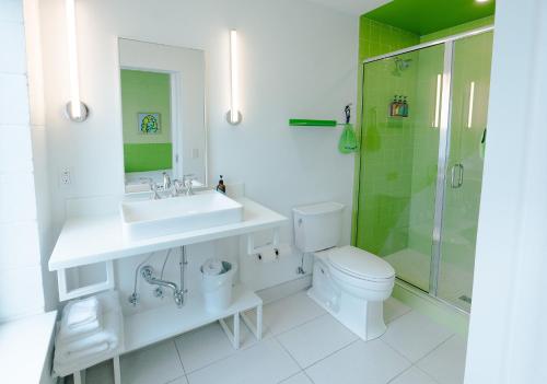 a bathroom with a sink and a shower and a toilet at The Gallatin in Nashville