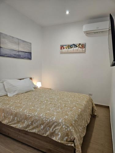 a bedroom with a bed and a painting on the wall at Santalucia Suite in Modugno