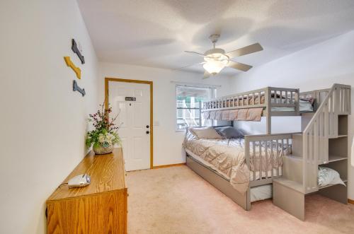 a bedroom with a bunk bed and a staircase at Cozy Lake Ozark Condo Rental with Grill, Pool Access in Lake Ozark