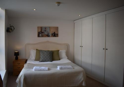 a bedroom with a large bed with white cabinets at Canal Walk - Chichester City Centre Apartment in Chichester