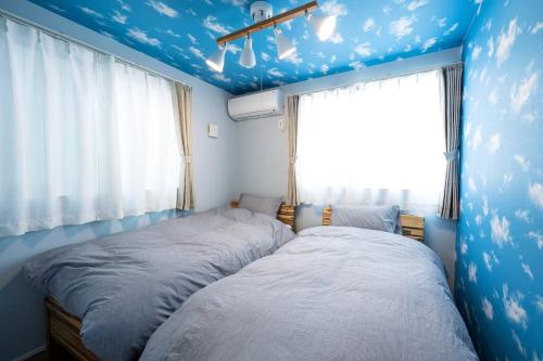 Postel nebo postele na pokoji v ubytování Aile House Ⅰ