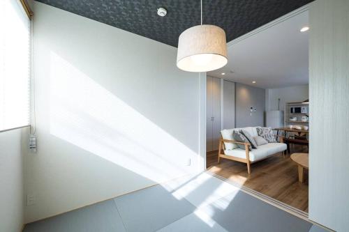 a living room with a chair and a table at Aile House Ⅰ in Takasaki