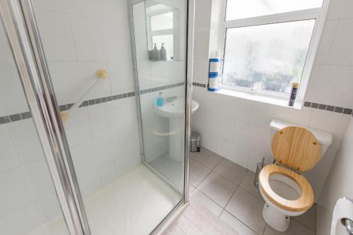 a bathroom with a shower and a toilet and a sink at Cosy Family Home in Ruislip in Ruislip
