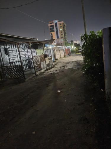 an empty street in a city at night at Nest Haven Homestay-Hostel in Dar es Salaam