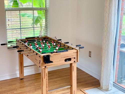 a wooden foosball table in a room at New! Close To Beach, Cozy, New beds & Family Friendly in Navarre