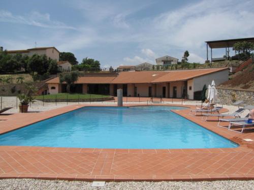 a large blue swimming pool in front of a house at La Pergola in Diaccialone