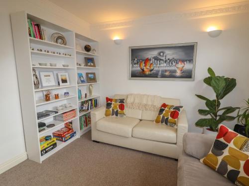 a living room with a couch and book shelves at 8 Nicholas Court in Chester