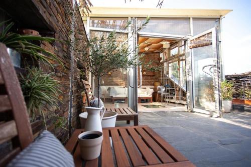 a patio with a wooden bench and potted plants at Art Villa Bucharest in Bucharest