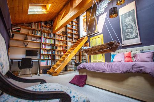 a room with a bed and a book shelf at Art Villa Bucharest in Bucharest
