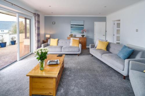 a living room with two couches and a coffee table at Gwbert Holiday Cottages, Gwynt Y Mor in Cardigan