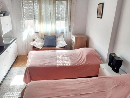two beds in a small room with a kitchen at 3 bedrooms apartement with city view and wifi at Amora 8 km away from the beach in Amora