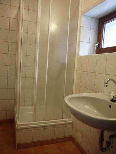 a bathroom with a shower and a sink at Gästezimmer mit Garten - b59462 in Werneuchen